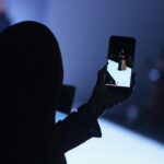 person using phone doing video of woman